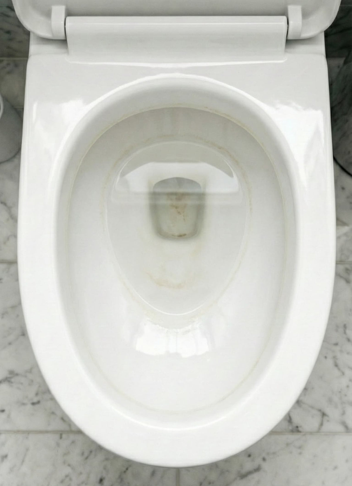 Before LAVO: toilet bowl with yellow limescale ring and stains