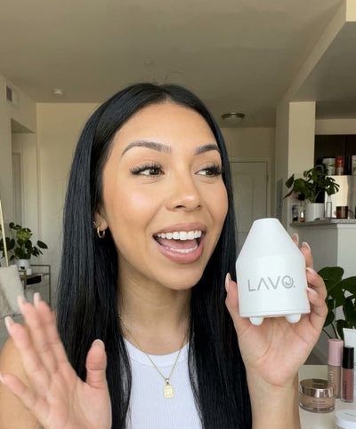 Woman holding the LAVO Pod on a sunny day outside next to her face